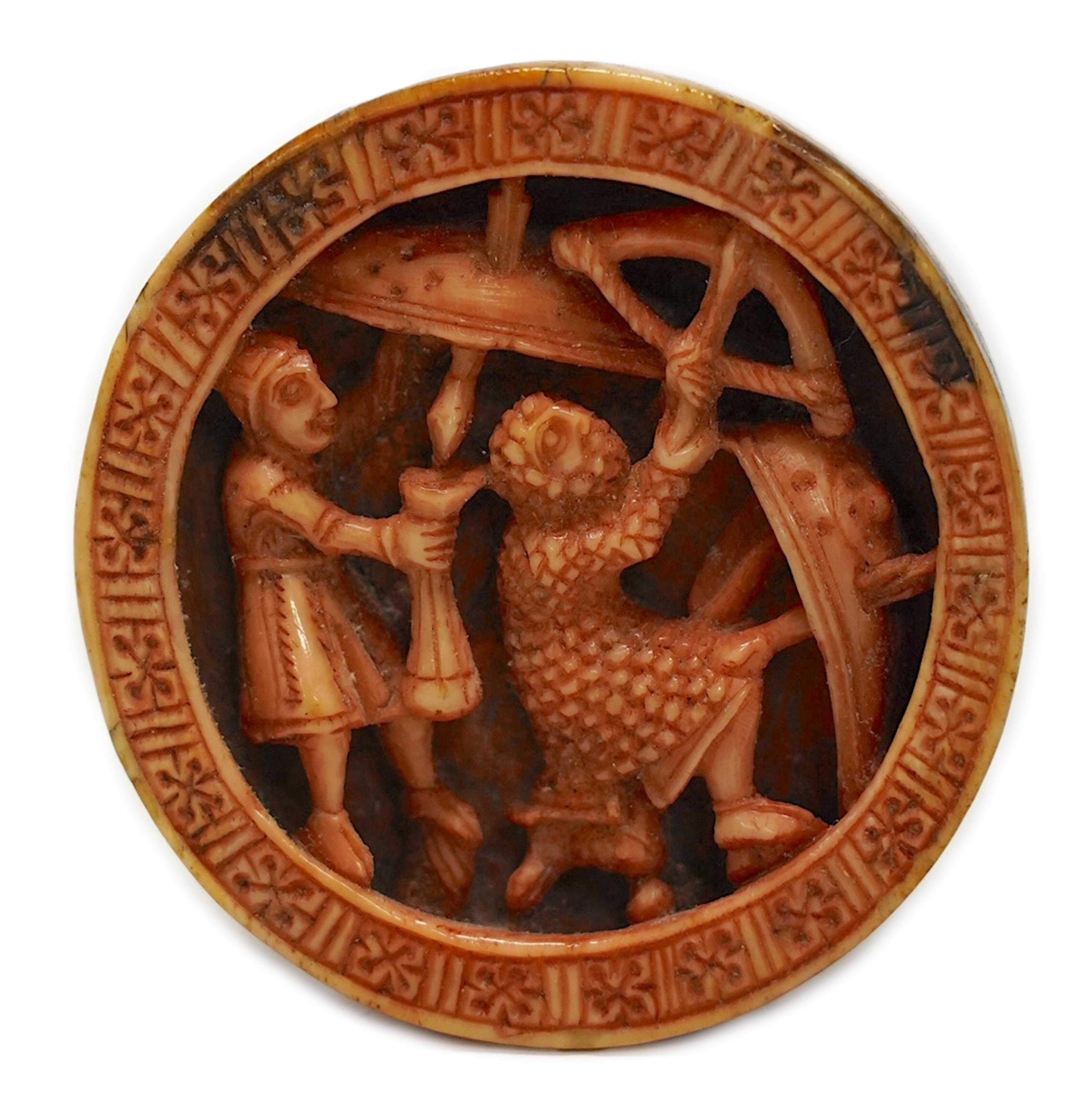 A Romanesque madder stained walrus ivory Tableman or gaming piece, Cologne, c.1140-1180 AD